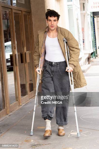 Christopher Abbott is seen out and about using crutches on December 30, 2023 in New York, New York.