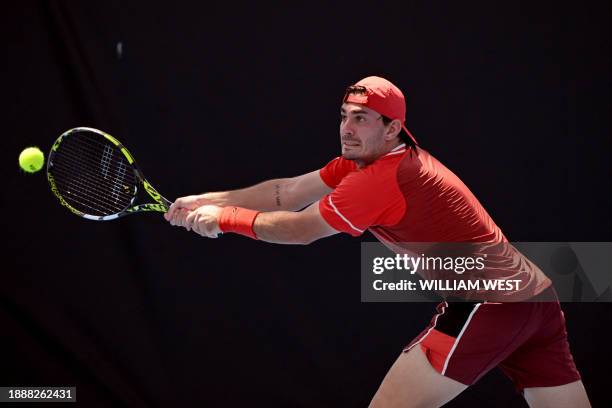 Italy's Giulio Zeppieri hits a return during his men's singles match against Austria's Dominic Thiem at the Brisbane International tennis tournament...