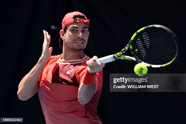 Italy's Giulio Zeppieri hits a return during his men's singles match against Austria's Dominic Thiem at the Brisbane International tennis tournament...