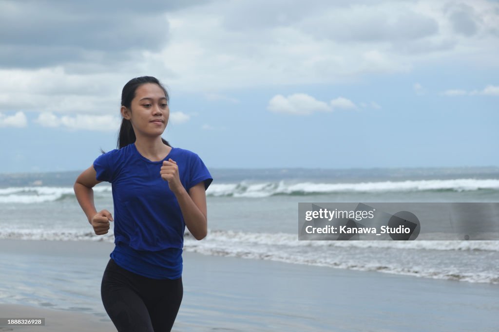 Indonesian Young Woman Exercise Running at The Beach