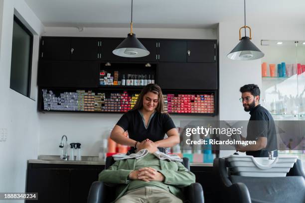 woman is washing a client's hair - newspaper cutting stock pictures, royalty-free photos & images