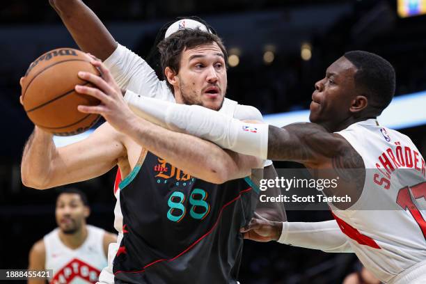 Danilo Gallinari of the Washington Wizards fights for the ball against Dennis Schroder of the Toronto Raptors during the first half at Capital One...