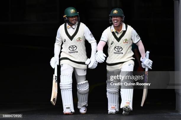 Usman Khawaja and David Warner of Australia share a laugh as they take to the field during day three of the Second Test Match between Australia and...