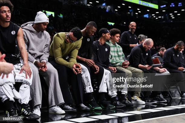 Brooklyn Nets players watch from the bench during the first quarter against the Milwaukee Bucks at Barclays Center on December 27, 2023 in New York...