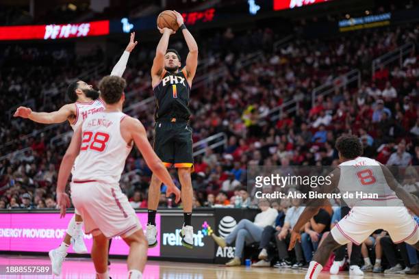 Devin Booker of the Phoenix Suns shoots a three point shot during the second quarter of the game against the Houston Rockets at Toyota Center on...