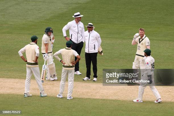 Players and umpires gather as they wait for the start of play after lunch during day three of the Second Test Match between Australia and Pakistan at...