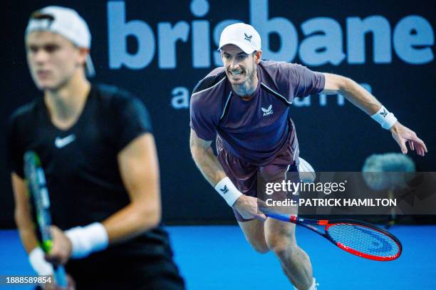 Britain's Andy Murray hits a return during his men's doubles match with partner Holger Rune of Denmark against Russian duo Aslan Karatsev and Roman...