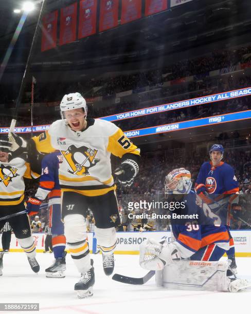 Jake Guentzel of the Pittsburgh Penguins scores a second period goal against Ilya Sorokin of the New York Islanders at UBS Arena on December 27, 2023...