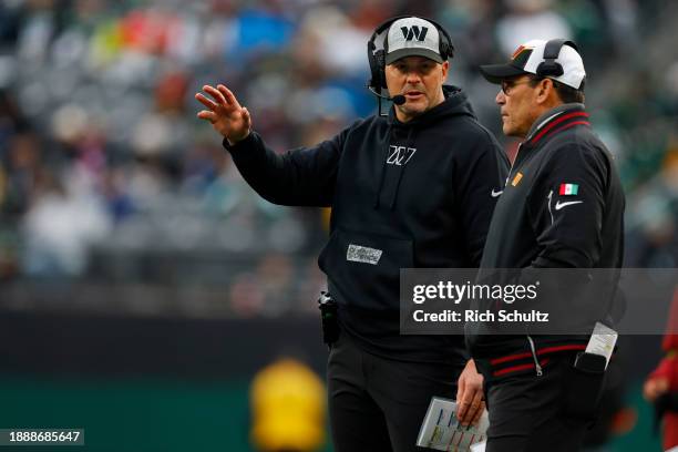 Head Coach Ron Rivera of the Washington Commanders, right, talks with linebackers coach Steve Russ during a game against the New York Jets at MetLife...