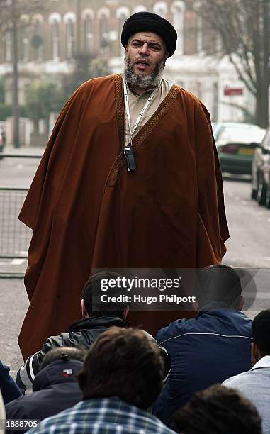 Radical Muslim Cleric Abu Hamza conducts a service of Friday afternoon prayers outside the Finsbury Park Mosque March 28, 2003 in London. An MP has...