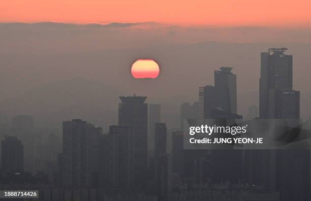 General view shows the last sunset of the year from Namsan tower in Seoul on December 31, 2023.