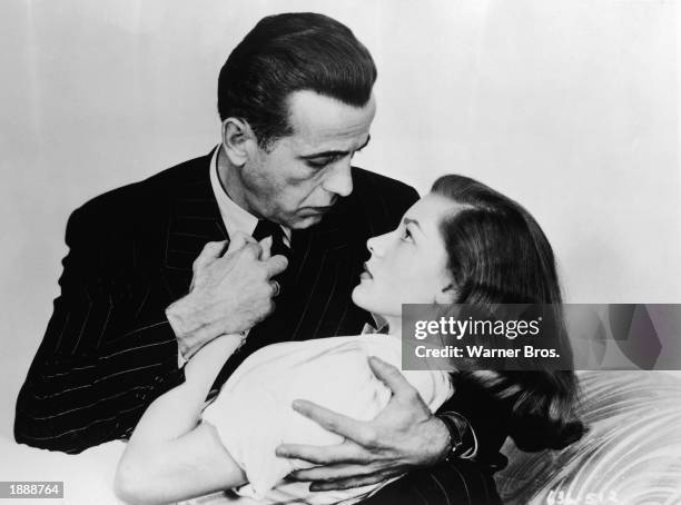 Promotional portrait of married American actors Humphrey Bogart and Lauren Bacall embracing for the film, 'The Big Sleep,' directed by Howard Hawks,...