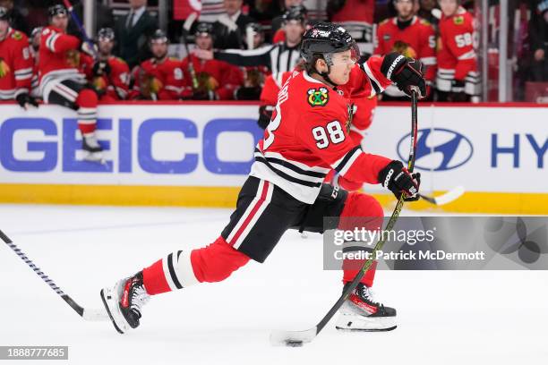 Connor Bedard of the Chicago Blackhawks shoots and scores the game winning goal during overtime against the Winnipeg Jets at the United Center on...