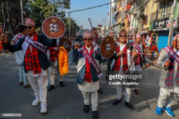 Nepalese men from the Gurung community dressed in traditional attire display traditional wepons as they take part in the parade to mark the Tamu...