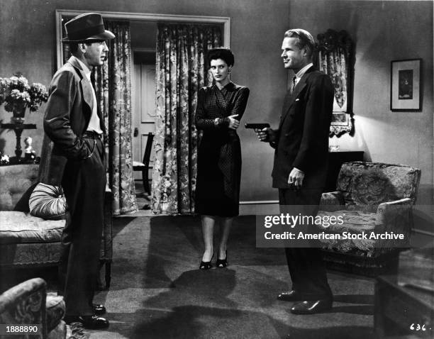 American actors : Humphrey Bogart, Sonia Darrin, and Louis Jean Heydt in a still from the film, 'The Big Sleep,' directed by Howard Hawks, 1946.