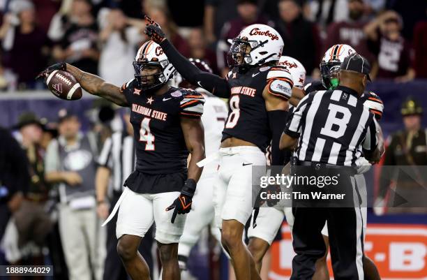 Nickolas Martin of the Oklahoma State Cowboys reacts after recovering a fumble in the fourth quarter against the Texas A&M Aggies during the TaxAct...