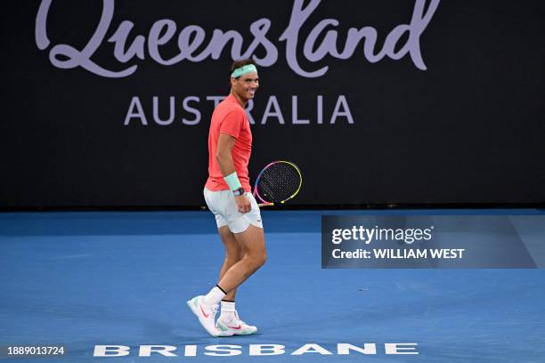 Spain's Rafael Nadal smiles while in action with partner Marc Lopez during their men's doubles match against Australia's Max Purcell and Jordan...