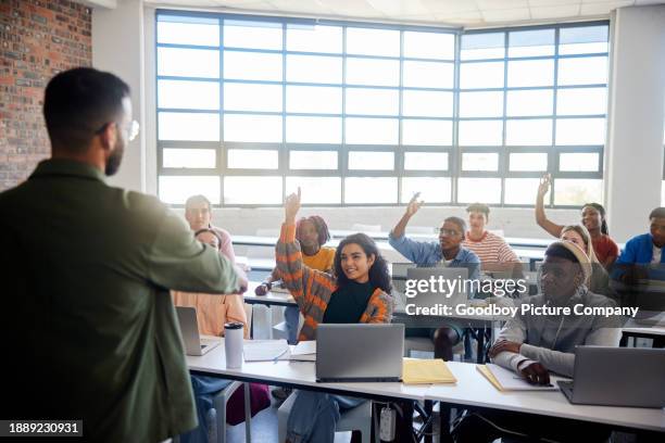 smiling students asking their teacher questions during a college class - technical college stock pictures, royalty-free photos & images