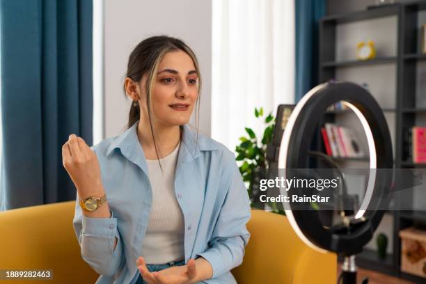 smiling young woman vlogger making a social media video - anel de luz imagens e fotografias de stock