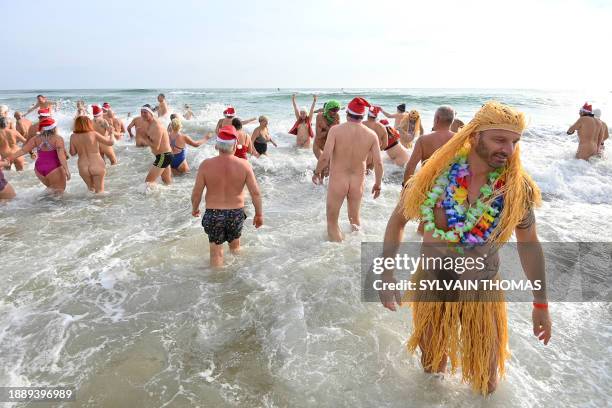 Graphic content / People take part in a traditional sea bath to mark the New Year's celebrations on a nudist beach in Le Cap d'Agde, southern France,...