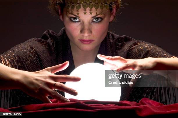 mysterious looking fortune teller - hands holding crystal ball stock pictures, royalty-free photos & images