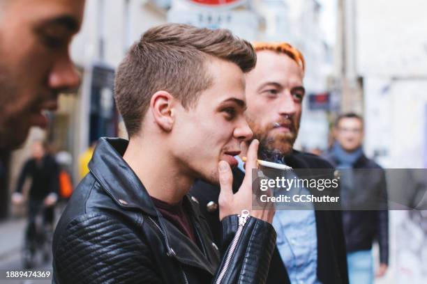 enjoying a smoke in the company of friends - passive smoking stock pictures, royalty-free photos & images