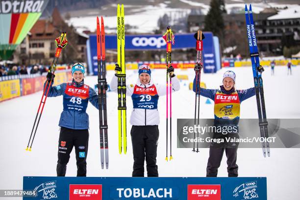 Second placed Victoria Carl of Germany, first placed Kerttu Niskanen of Finland and third Jessie Diggins of the United States celebrates at the...