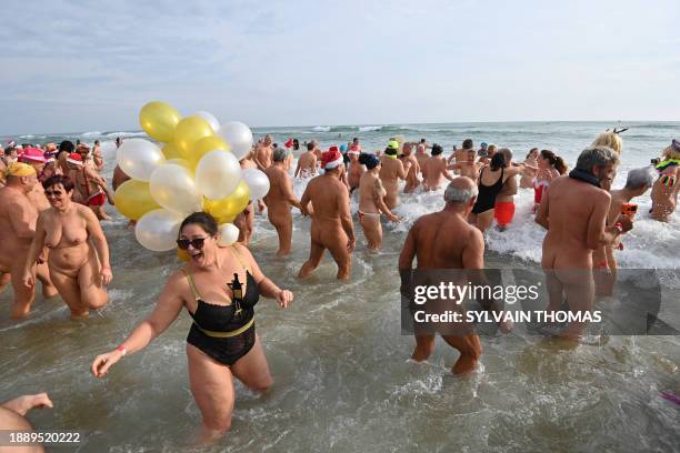 Graphic content / People take part in a traditional sea bath to mark the New Year's celebrations on a nudist beach in Le Cap d'Agde, southern France,...