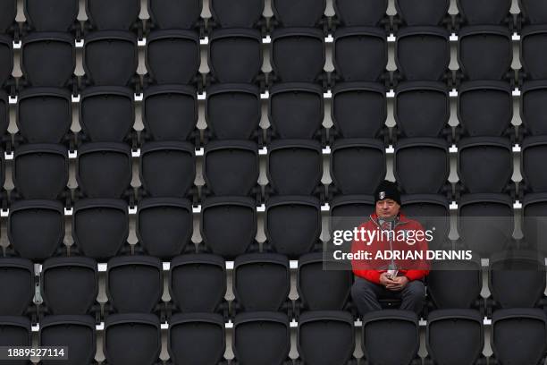 Fulham fan wearing an England shirt takes his seat in the grandstand for the English Premier League football match between Fulham and Arsenal at...