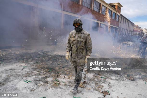 Revelers take part in the 'Enfarinats' battle, a flour, egg and pyrotechnics fight to celebrate the Els Enfarinats festival on December 28, 2023 in...