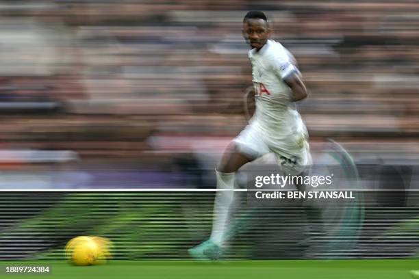 Tottenham Hotspur's Senegalese midfielder Pape Matar Sarr runs with the ball during the English Premier League football match between Tottenham...
