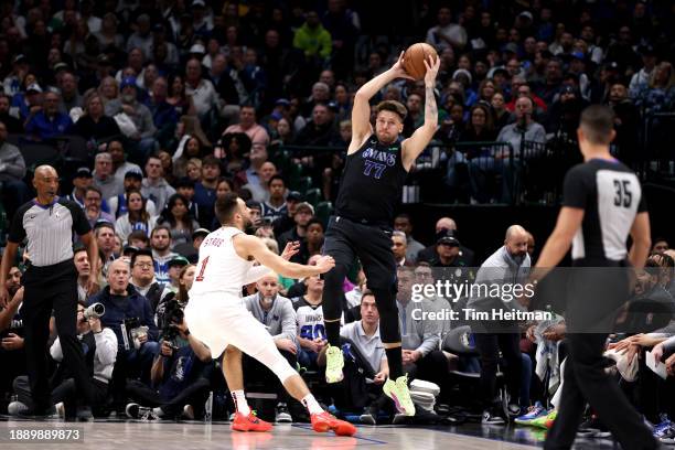 Luka Doncic of the Dallas Mavericks catches a pass while defended by Max Strus of the Cleveland Cavaliers in the first half at American Airlines...