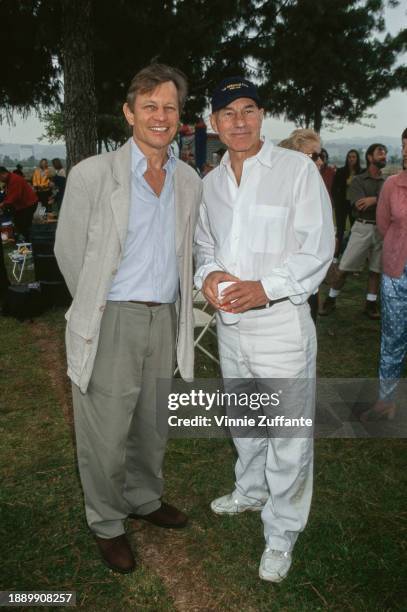 British actor Michael York poses beside British actor Patrick Stewart, wearing cricket whites and a 'Meridian Club' cap, at a celebrity cricket match...