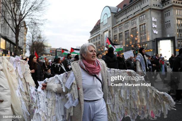 Protester wearing a wing shows her protest by writing the names of people who were killed in the Gaza War during the Palestinian demonstrators march...