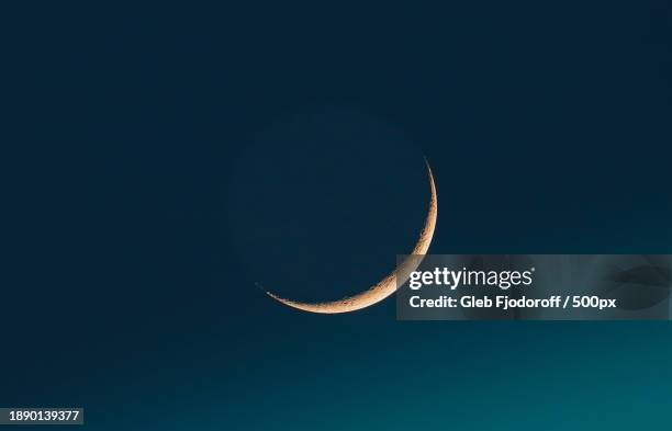 low angle view of moon against clear blue sky - crescent stock pictures, royalty-free photos & images