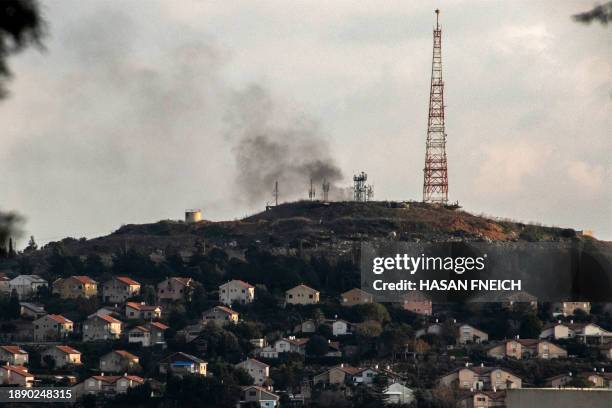 This picture taken on December 31, 2023 from southern Lebanon shows smoke billowing across the border in northern Israel in the vicinity of a...