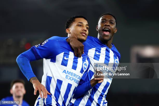 Joao Pedro of Brighton & Hove Albion celebrates after scoring their team's second goal from a penalty kick with teammate Danny Welbeck during the...