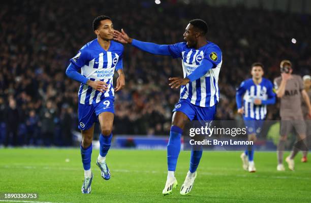 Joao Pedro of Brighton & Hove Albion celebrates after scoring their team's second goal from a penalty kick with teammate Danny Welbeck during the...