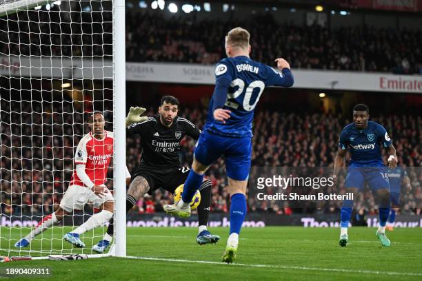 David Raya of Arsenal looks on as Jarrod Bowen of West Ham United controls the ball on the goal line during the Premier League match between Arsenal...