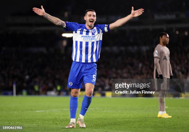 Lewis Dunk of Brighton & Hove Albion celebrates after Pervis Estupinan scores their team's third goal during the Premier League match between...