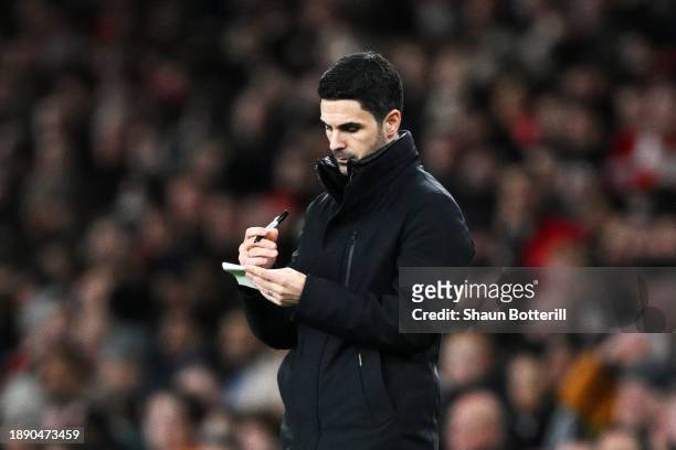Mikel Arteta, Manager of Arsenal, writes on a notepad during the Premier League match between Arsenal FC and West Ham United at Emirates Stadium on...