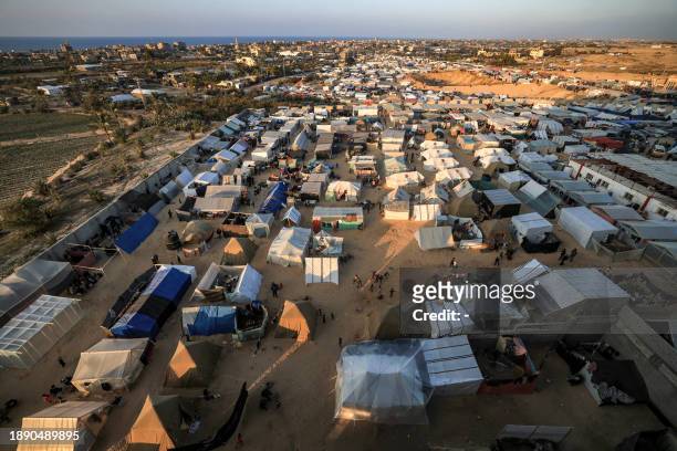 The tent camps of displaced Palestinians are pictured in Rafah in the southern Gaza Strip close to the border with Egypt at sunset on December 31,...