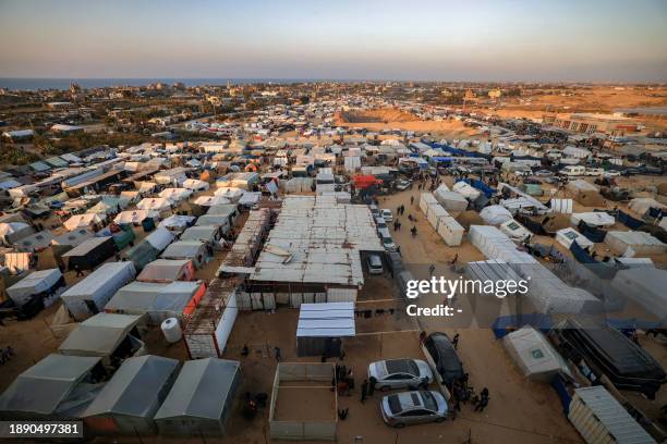 The tent camps of displaced Palestinians are pictured in Rafah in the southern Gaza Strip close to the border with Egypt at sunset on December 31,...