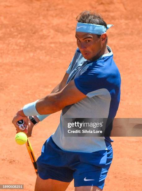 Rafael Nadal of Spain returns a backhand to John Isner of USA in their 2nd Round Singles match on day three of the Internazionali BNL D'Italia at...