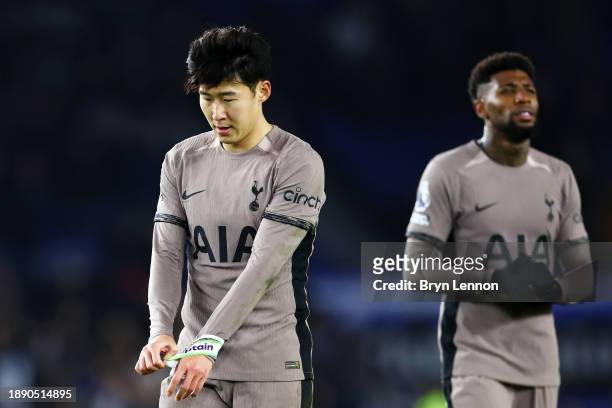 Son Heung-Min of Tottenham Hotspur removes his captains armband as he looks dejected after defeat to Brighton & Hove Albion during the Premier League...
