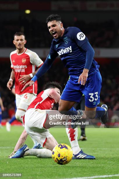 Declan Rice of Arsenal fouls Emerson Palmieri of West Ham United, which results in a penalty for West Ham United, during the Premier League match...