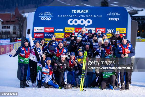 Perttu Hyvarinen of Finland celebrates with the team after the award ceremony for winning the FIS World Cup Cross - Country Tour de Ski 10km on...