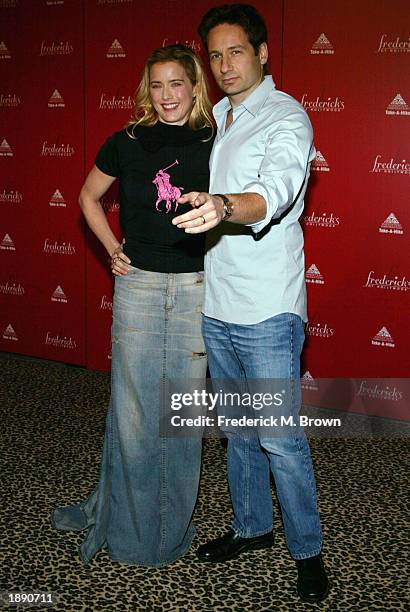 Actor David Duchovny with his wife, actress Tea Leoni, attend the Frederick's of Hollywood Fall 2003 fashion show and auction at Smashbox Studios...