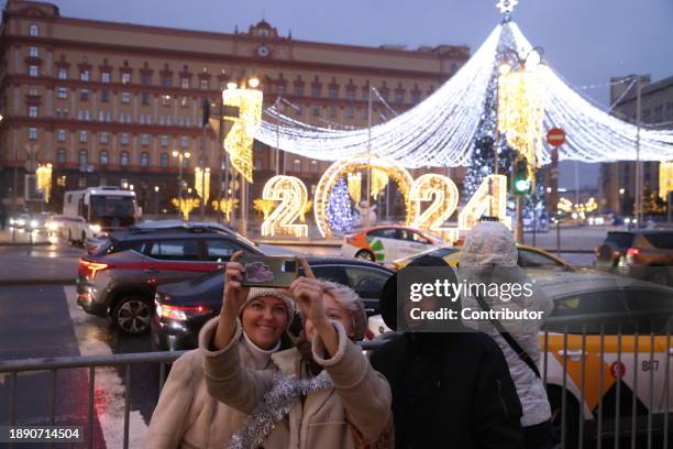 People take a selfie near the Chritsmas tree at Lubyanka square in front of the main building of the Federal Security Service , know as KGB in the...