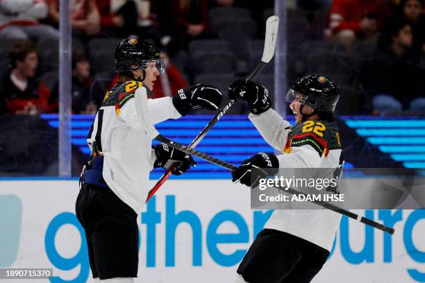 Germany's forward Julius Sumpf celebrates scoring the 3-3 goal with Germany's defender Jakob Weber during the Group A ice hockey match between Canada...
